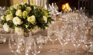 close up of glassware setting with floral centerpiece during the Valentine's Day Dinner in the dining room at Jordan Winery