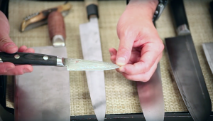 close up of hands holding a Ittosai petty knife