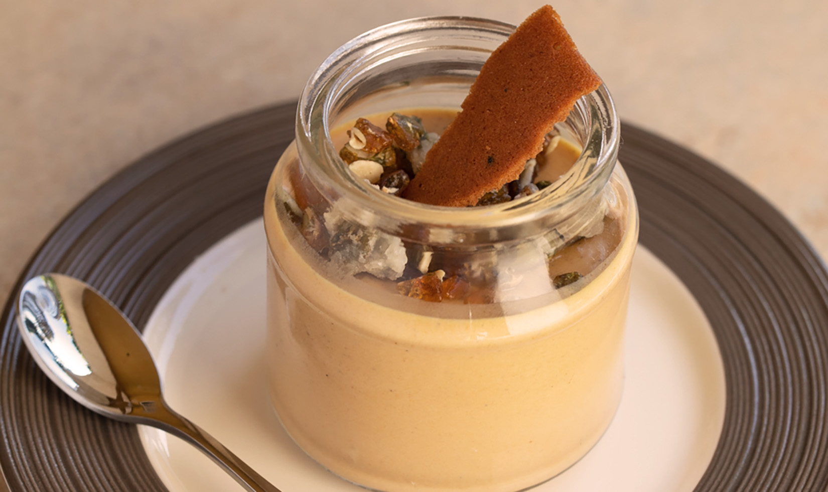 close up of Jordan Winery pumpkin panna cotta dessert in a glass jar