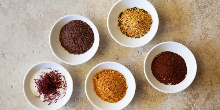 5 small bowls of different colored spices