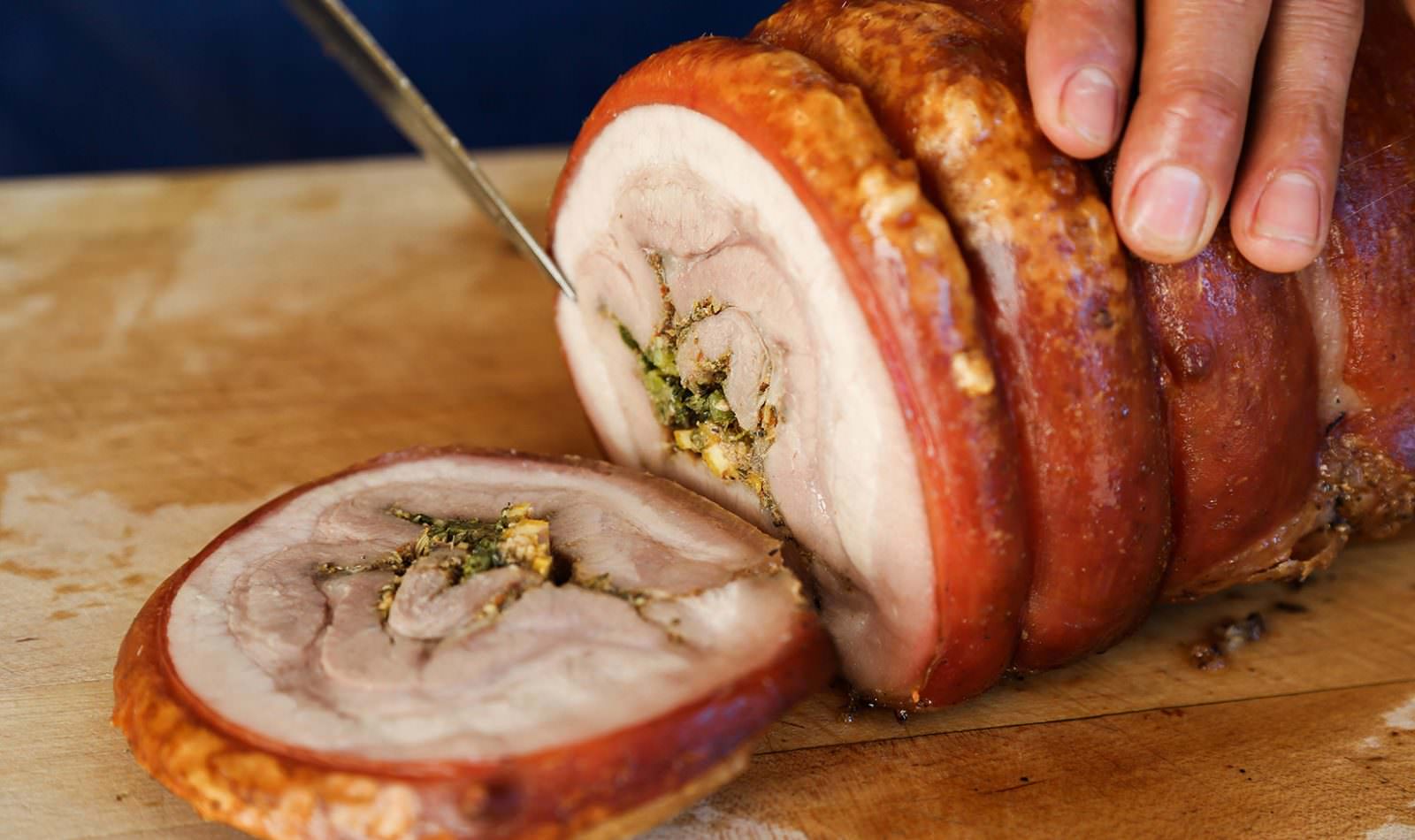 knife slicing the cooked Jordan Winery Herb Roasted Pork Belly Porchetta