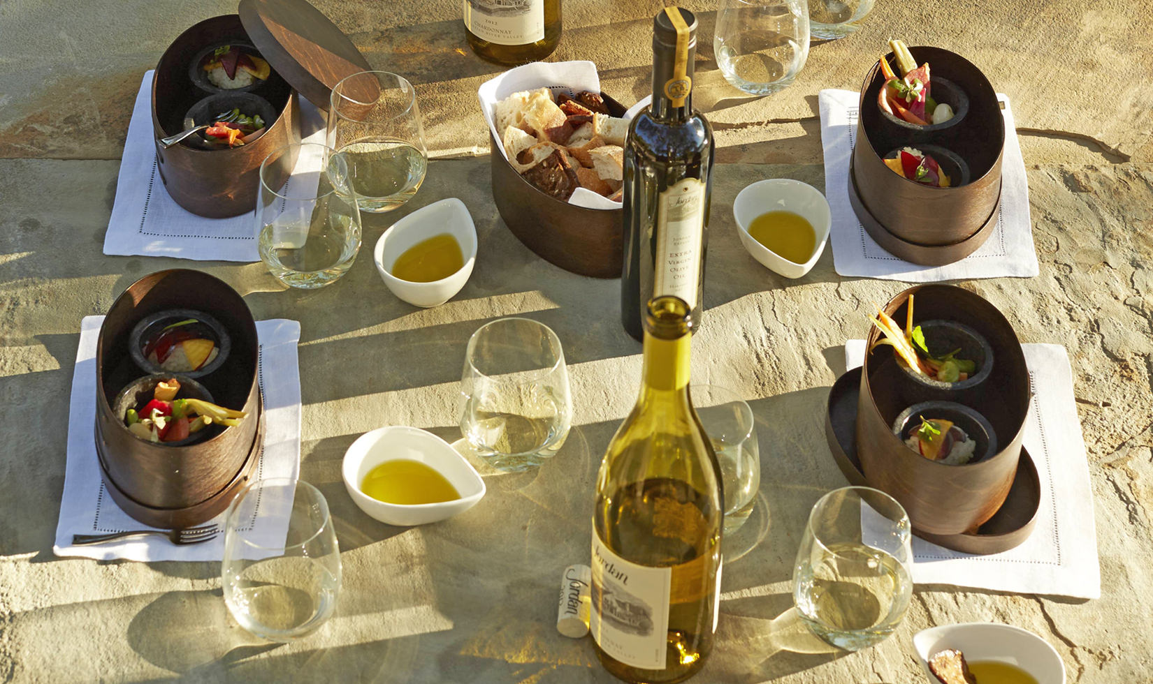 table setting for Jordan Winery Estate Tour & Tasting with Jordan Winery Chardonnay with small bento boxes and Jordan Winery extra virgin olive oil