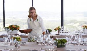 Director of Hospitality Nitsa Knoll setting glasses on dining table for Jordan's annual Sunset Supper at Vista Point