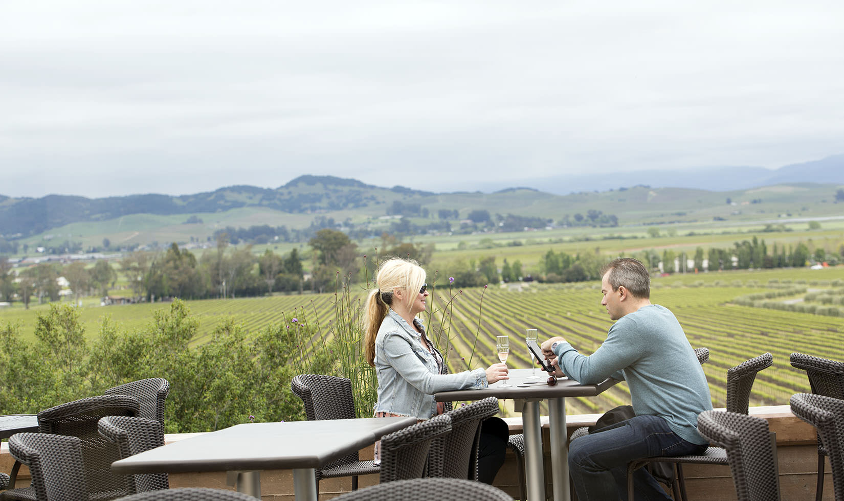 two guests sitting at an outdoor table on the Gloria Ferrer patio