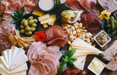 close up of a charcuterie and cheese board with marcona almonds and olives