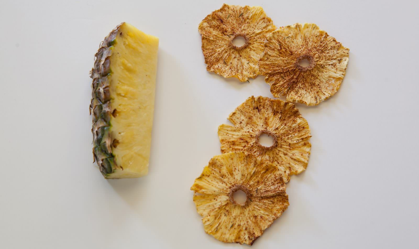 slice of pineapple next to slices of dehydrated pineapple