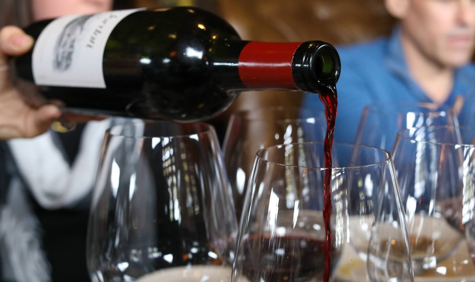 Jordan Cabernet Sauvignon pouring into an empty wine glass to pair with a filet or ribeye steak.