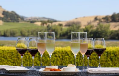 alfresco table setting for wine and cheese tasting with the view from Domaine Carneros terrace in background