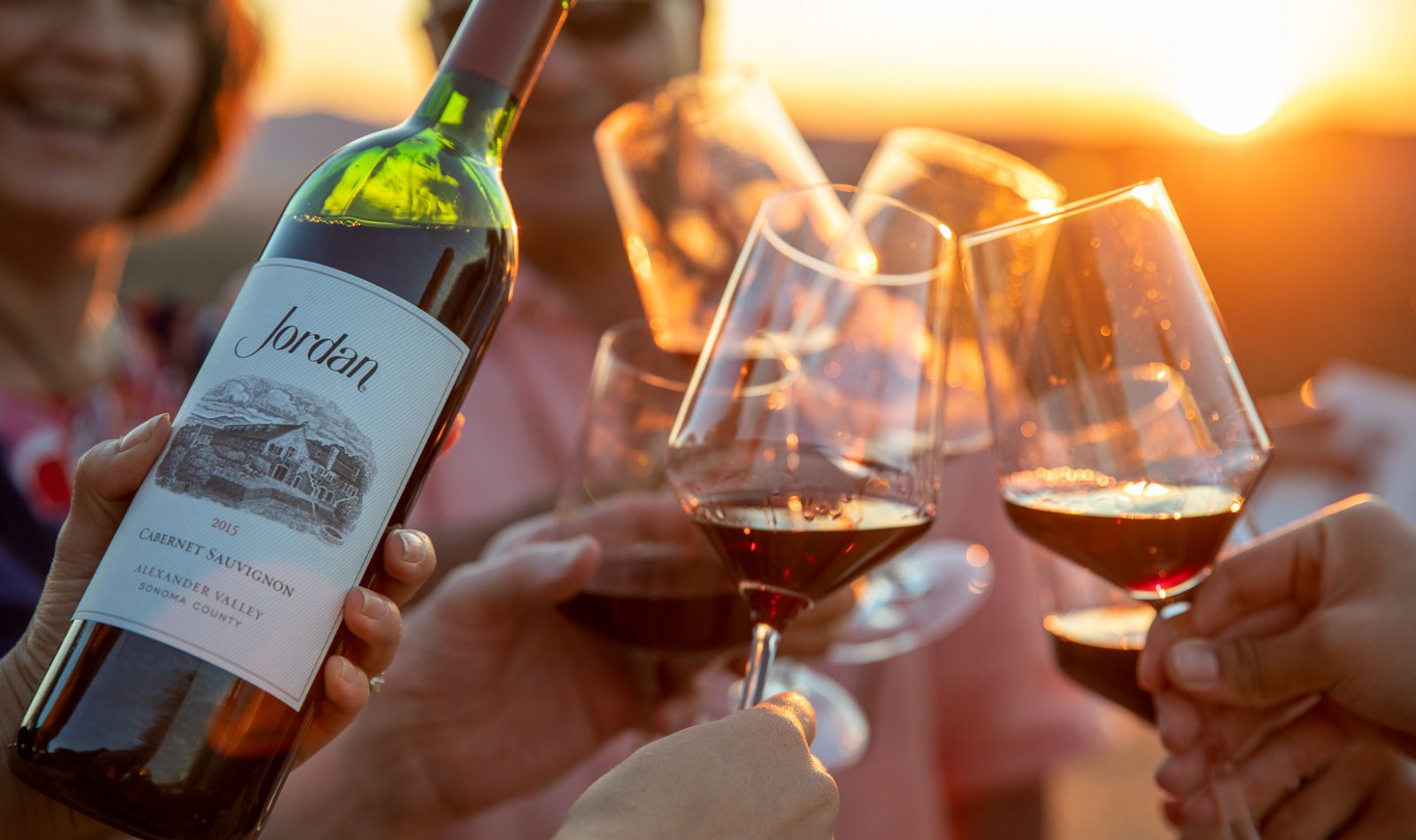 wine glass toast at sunset supper event at Jordan Winery with Jordan Winery Cabernet