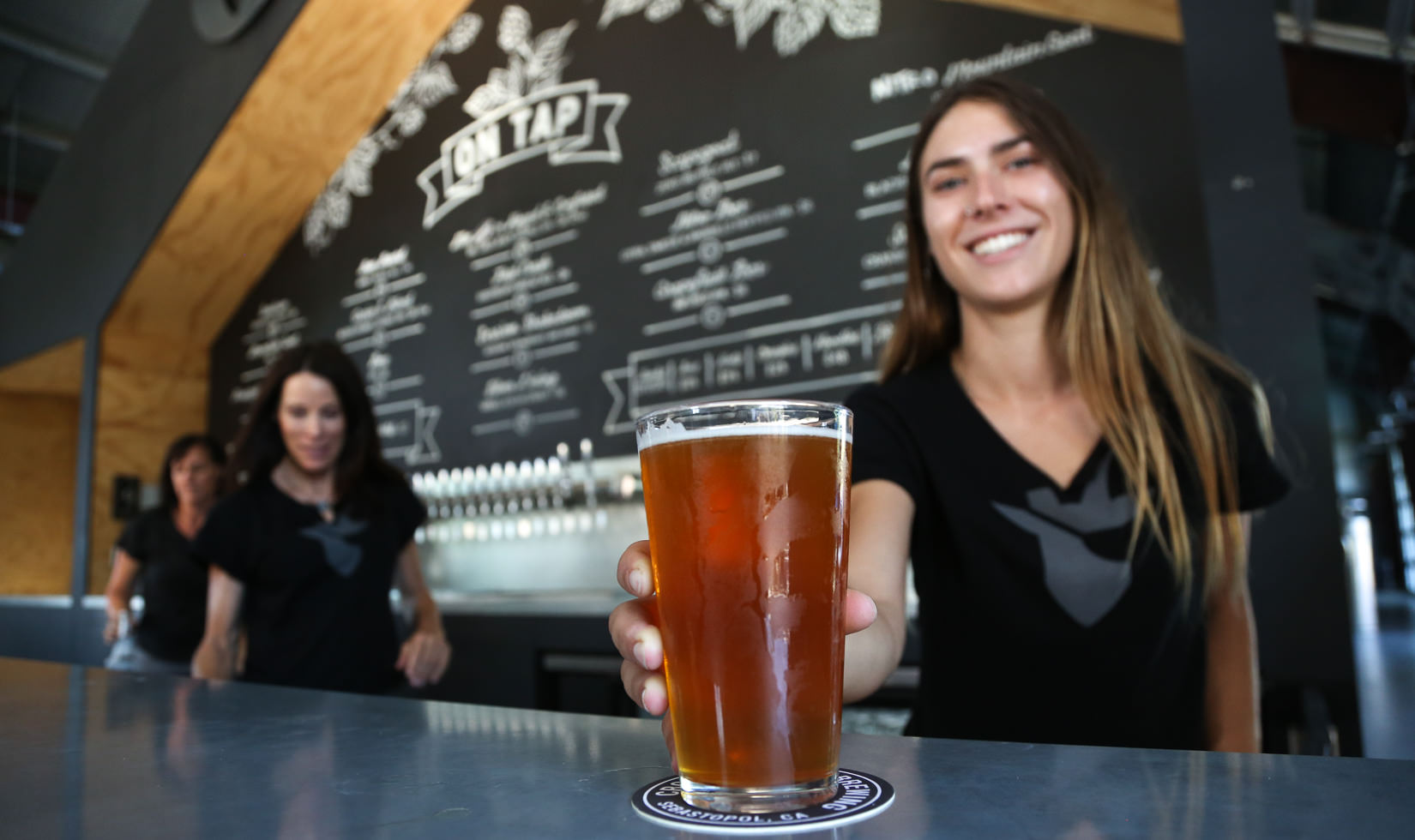 Bartender serving pint, Crooked Goat Brewery, Grapefruit Ibex Beer