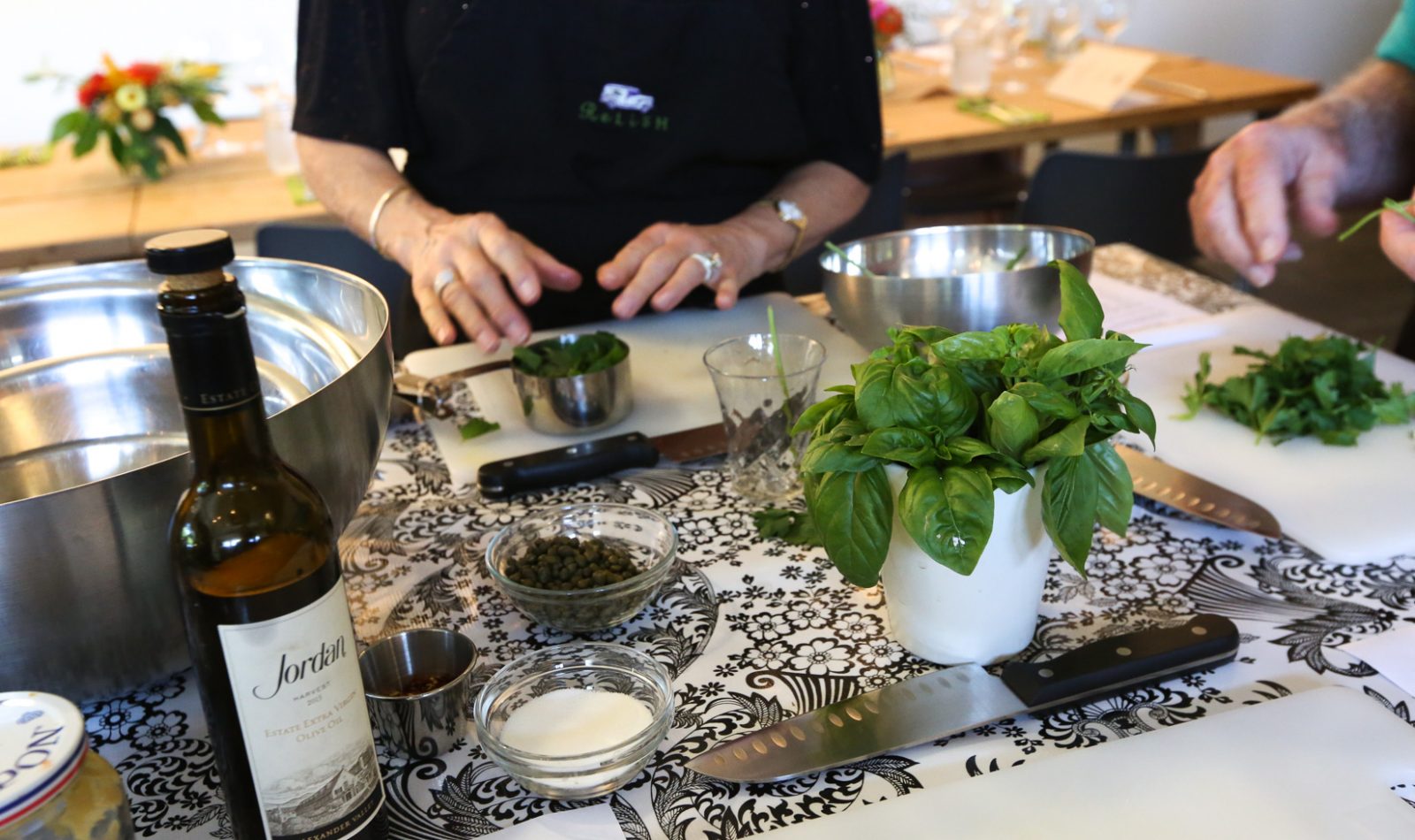 Jordan Winery olive oil and basil on a kitchen counter at a cooking class at Relish