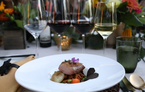 place setting with entree and wine flight at Bounty Summer Dinner at Jordan Winery