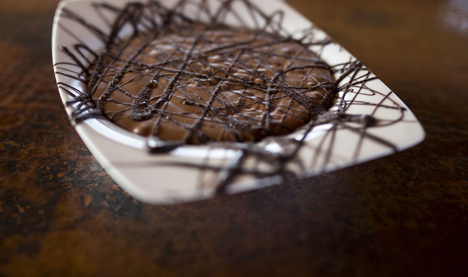 close up of Jordan Winery Easy Chocolate Mousse with dark chocolate drizzle