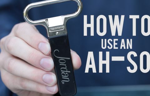 hand holding a Jordan Winery logo ah-so wine bottle opener with image text "how to use an ah-so"