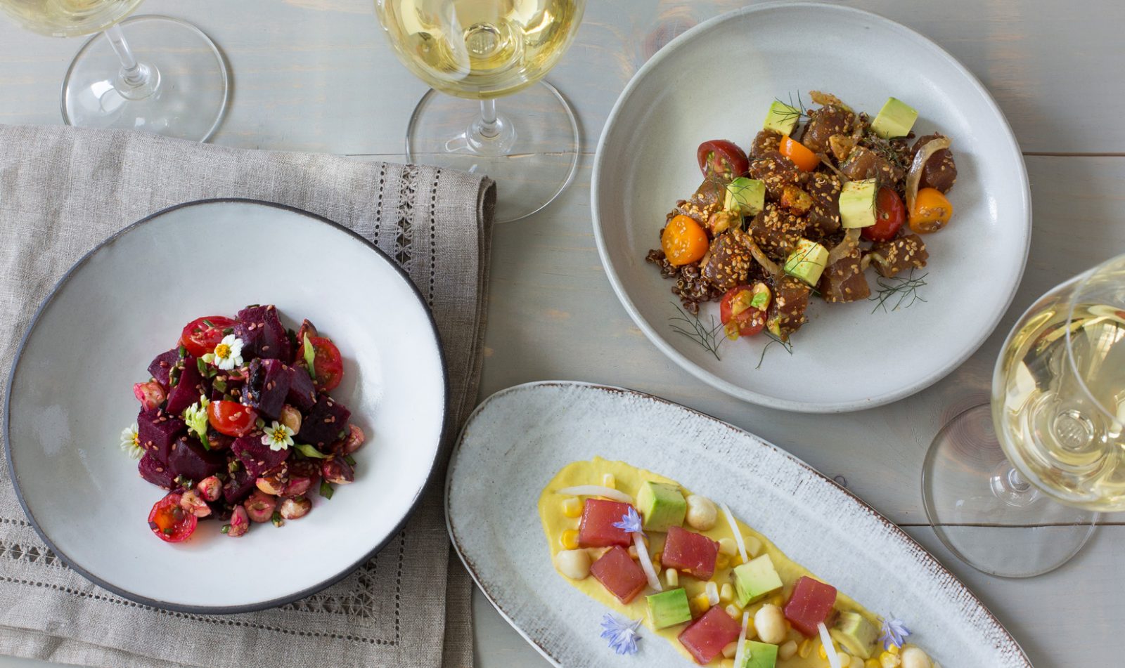 three ahi poke recipes with glasses of Chardonnay