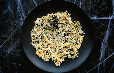 chocolate spiderwebs on a plate with a decorative fake spider