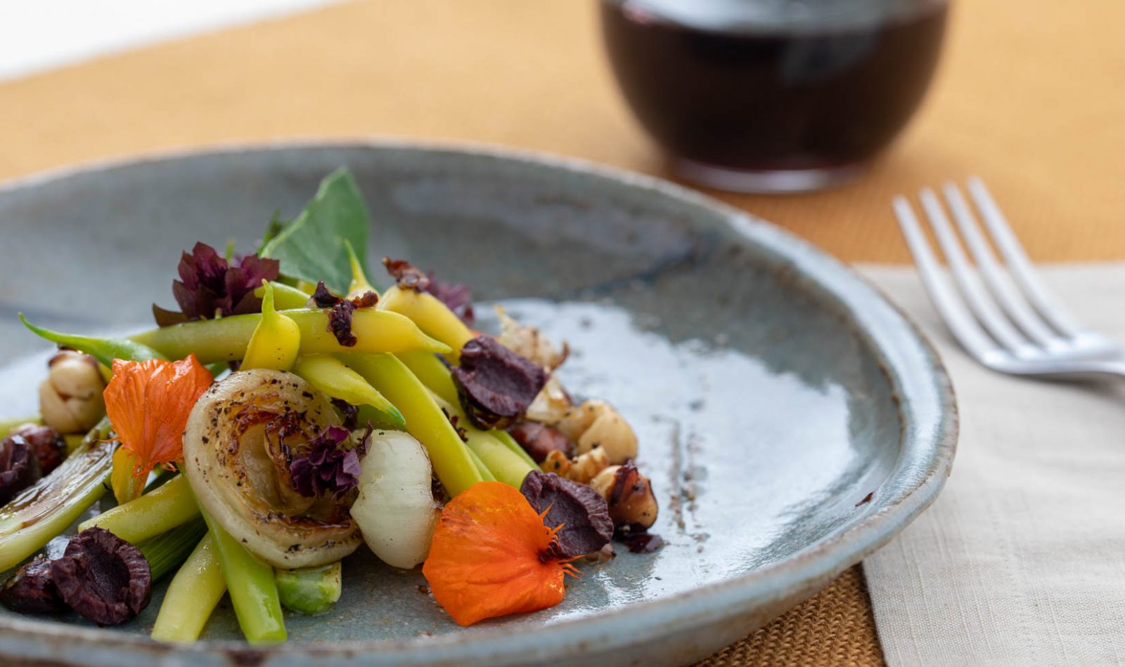 yellow wax bean salad with grilled onions and a glass of cabernet wine