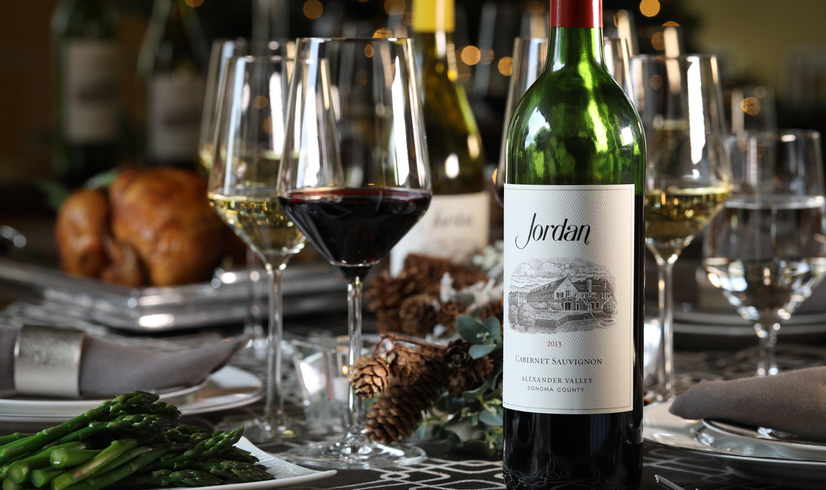Jordan Cabernet on a table next to asparagus and wine glasses
