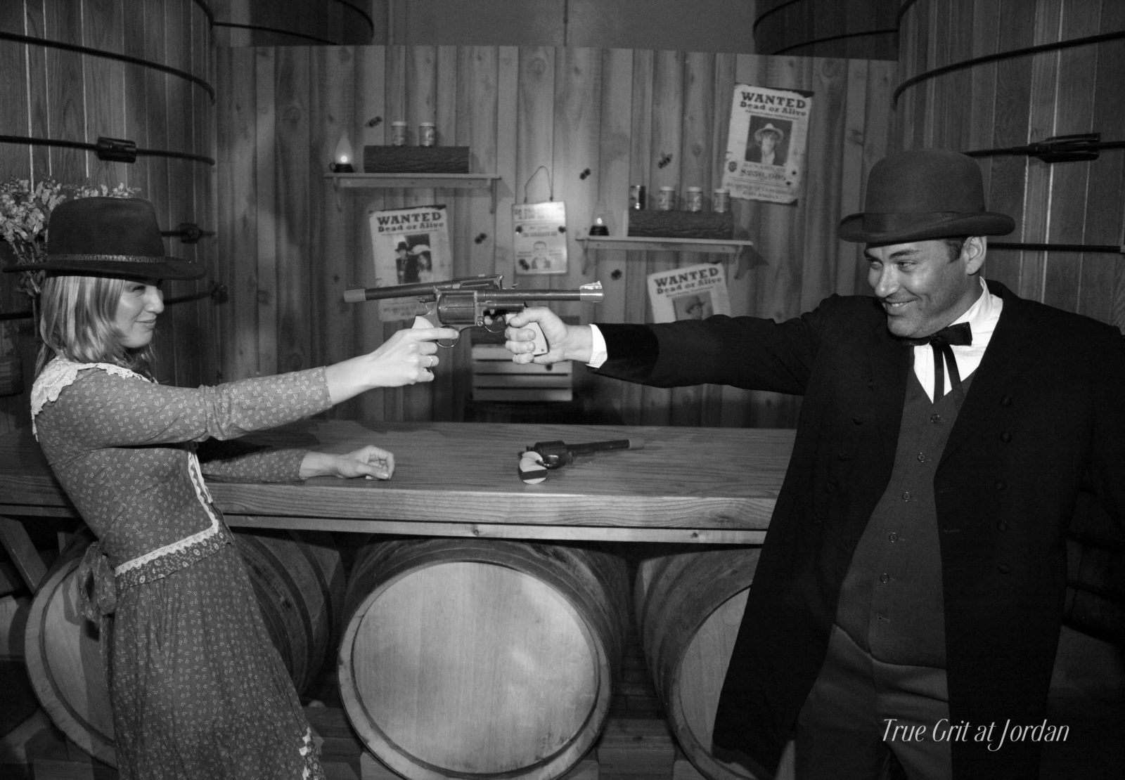 black and white photo of guests posing in costume at a True Grit themed halloween party at Jordan Winery