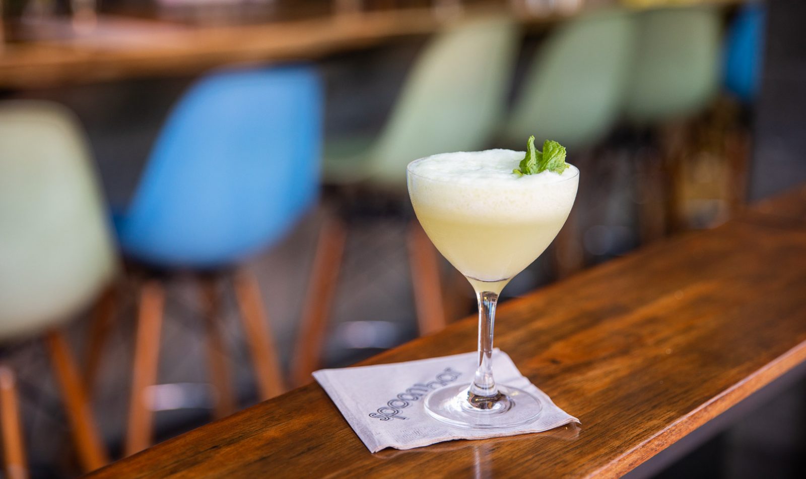 "New East Side" gin fizz cocktail with mint garnish at Spoonbar