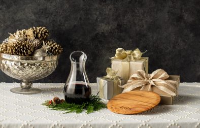 Jordan wine decanter, olive wood cheese board and presents on a table