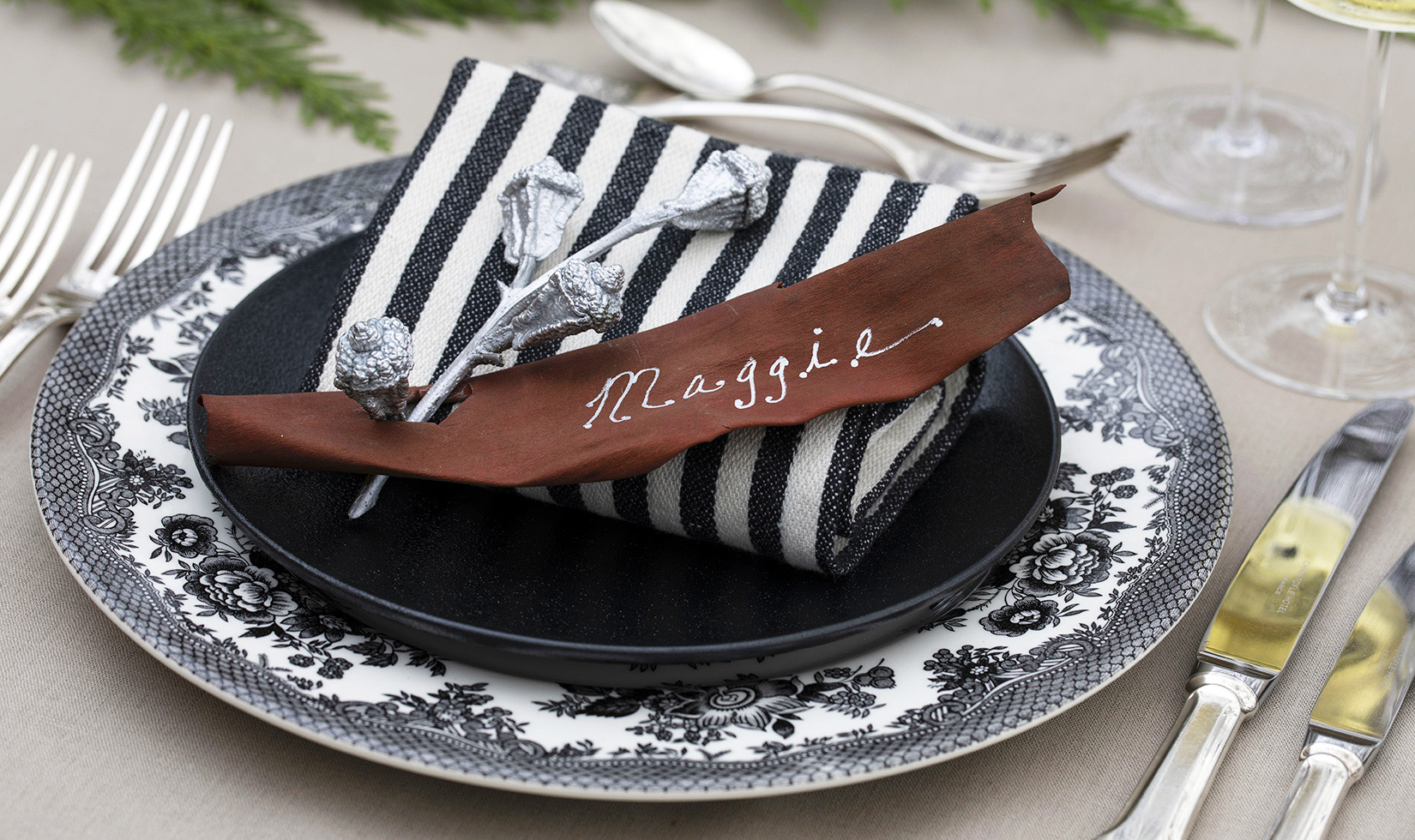 Jingle Bells Eucalyptus Pods Place Setting on black and white plates