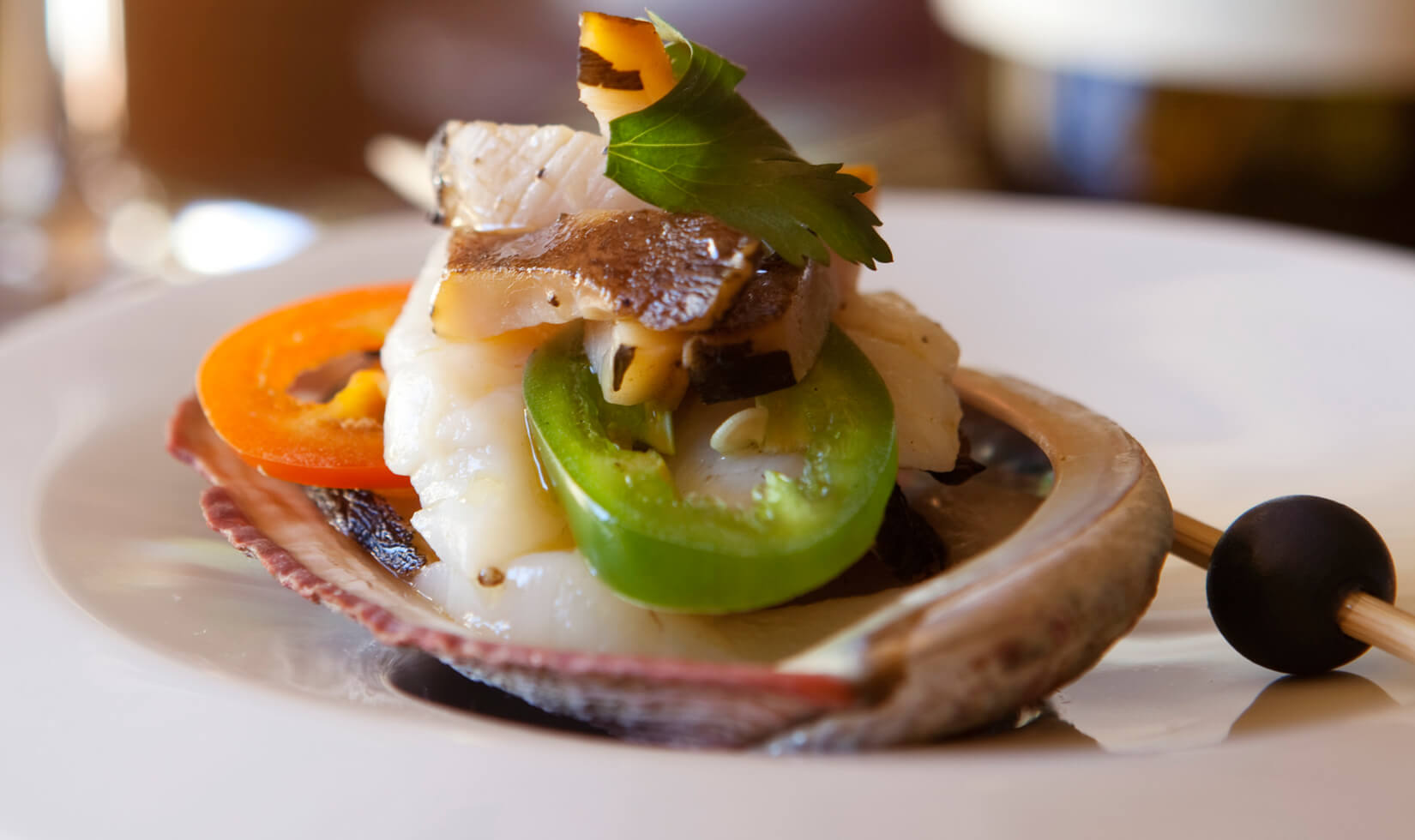 abalone tiradito appetizer in shell with jordan chardonnay