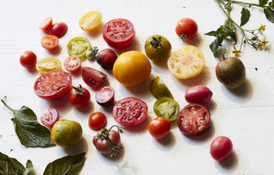 A variety of heirloom tomatoes on a white board