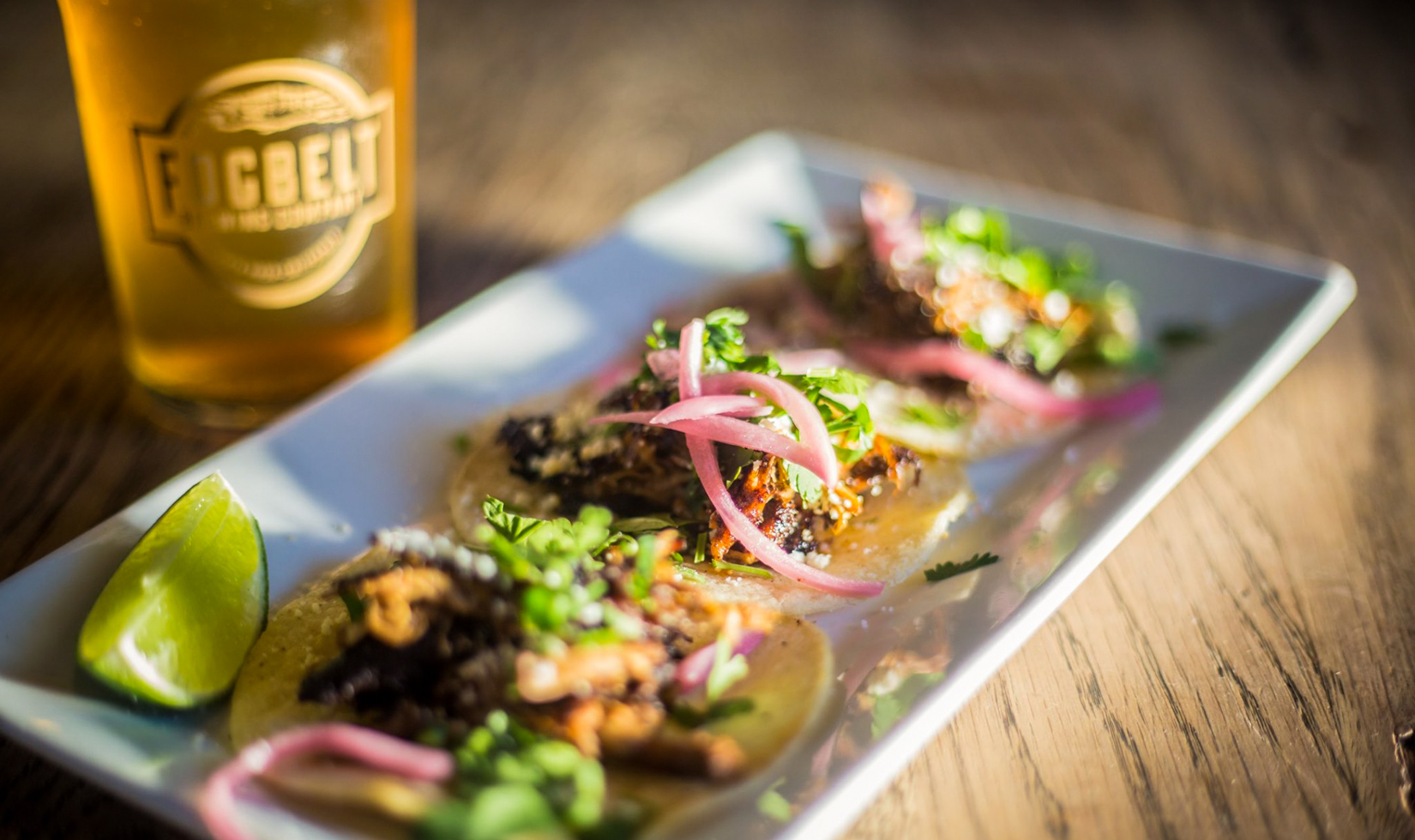 fogbelt brewery close up of pork tacos and beer on table