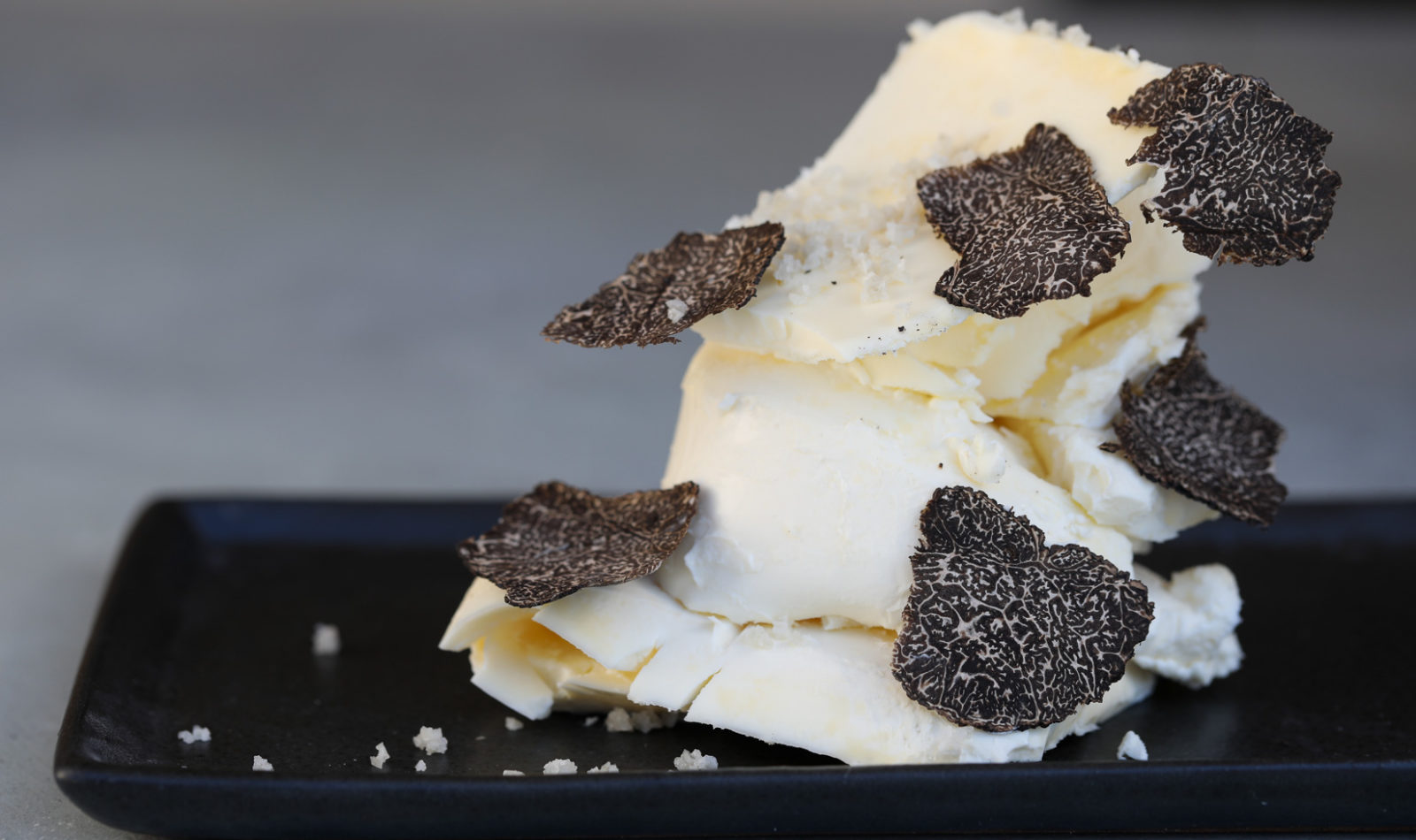 truffle butter sprinkled with sea salt on black plate