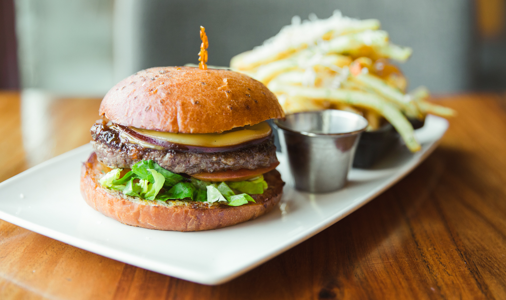 cheeseburger with french fries on white plate