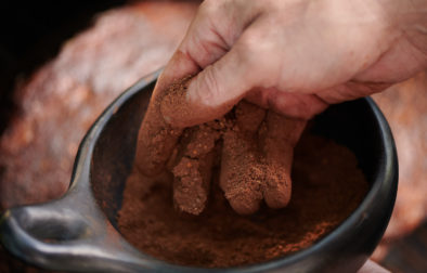 hand touching bowl of spiced rub