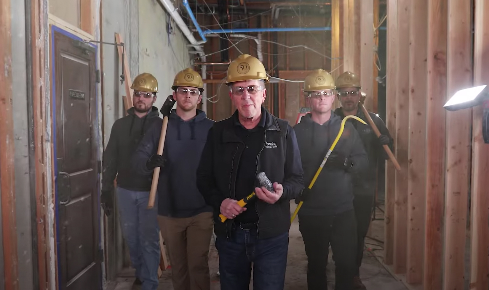 men with construction hats and hammers in construction site