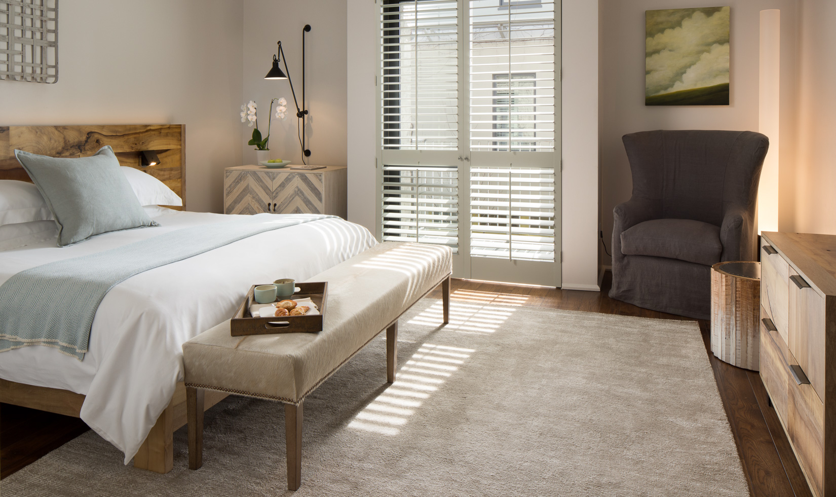 Elegant bedroom with natural light and cozy decor.