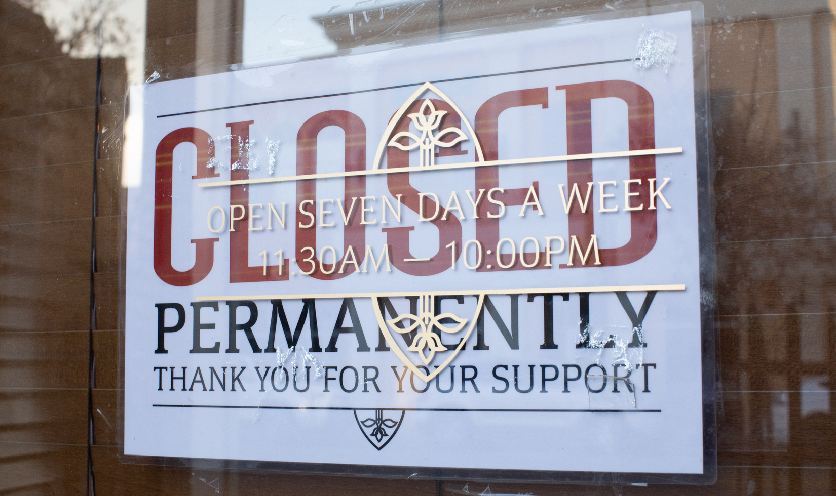 closed sign hanging outside of restaurant