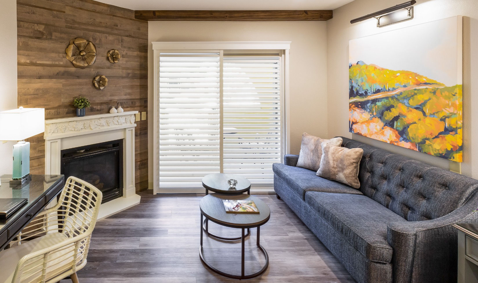 Modern living room with fireplace, wood accents, and cozy seating.