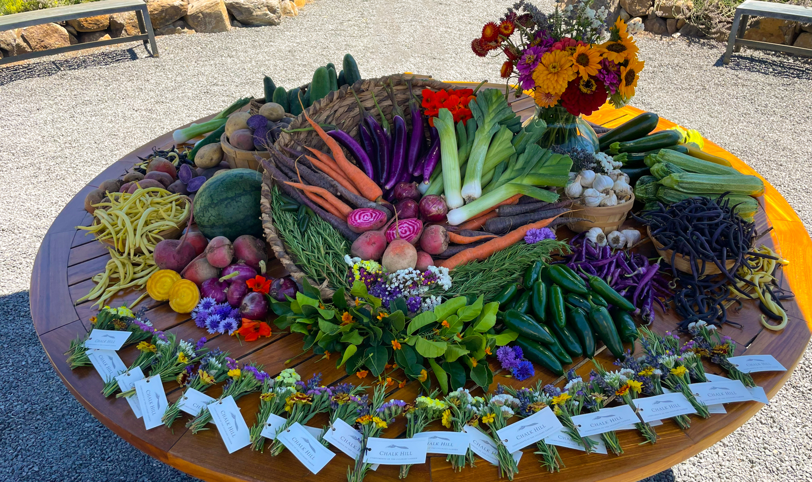 garden vegetables set on large round table outdoors