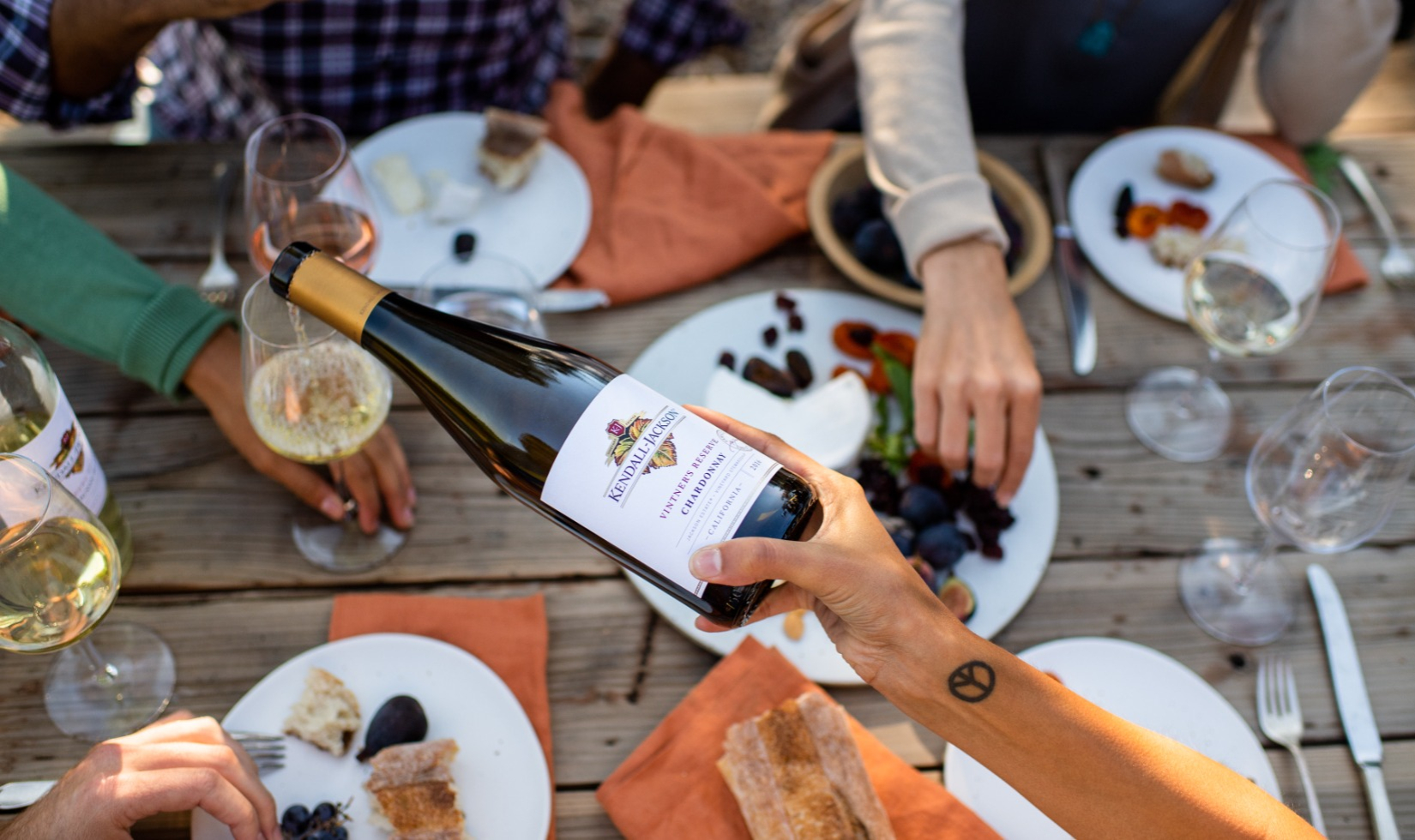 overhead shot of a woman pouring glass of chardonnay