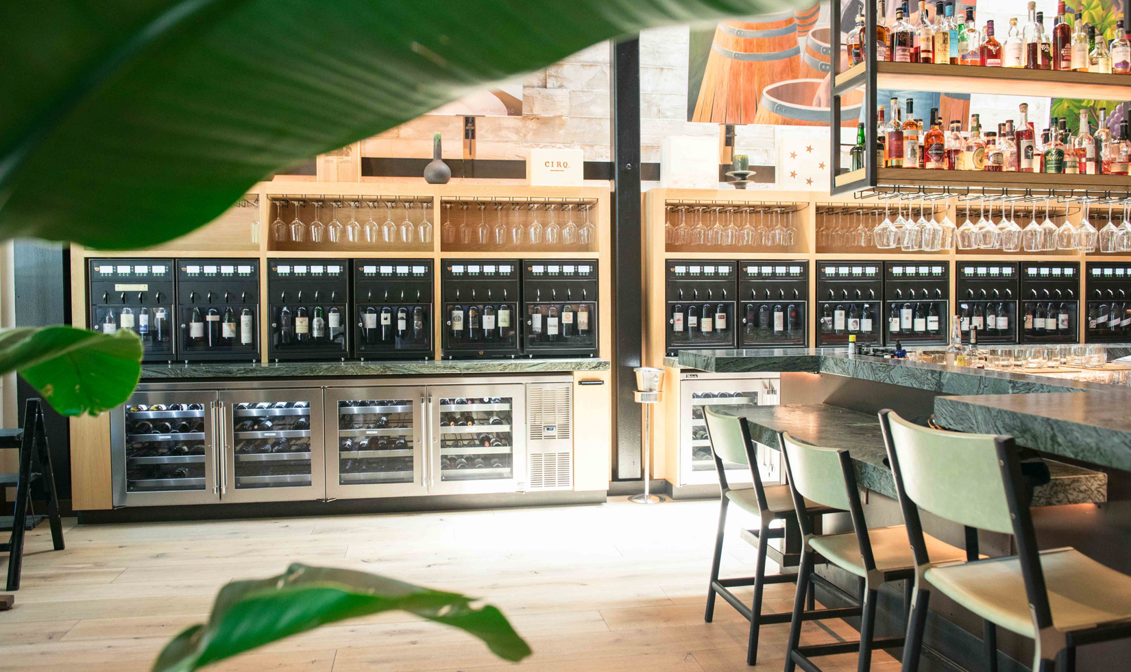 interior of wine wall with many wine bottles on display at a bar