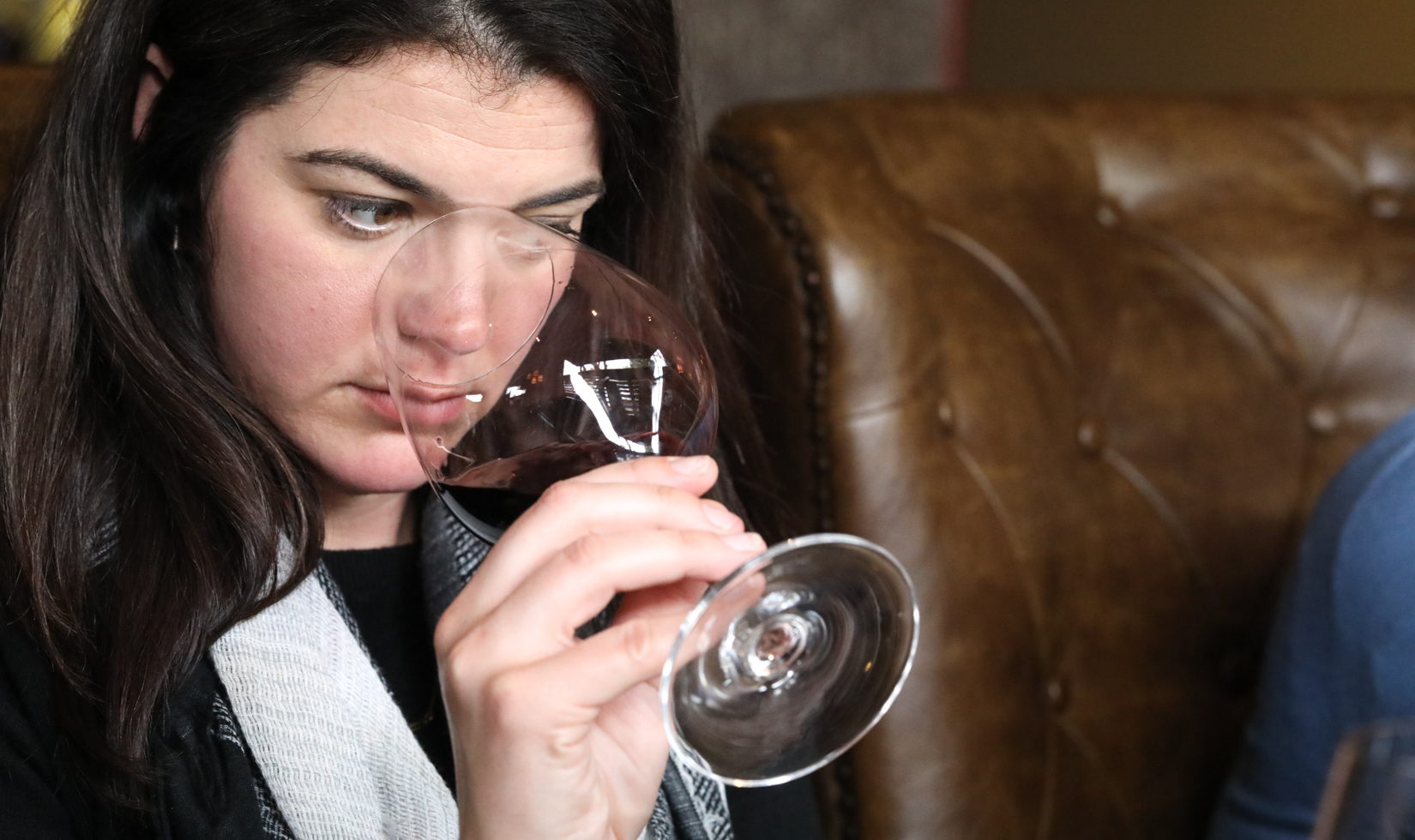 woman sniffing aromas from wine glass