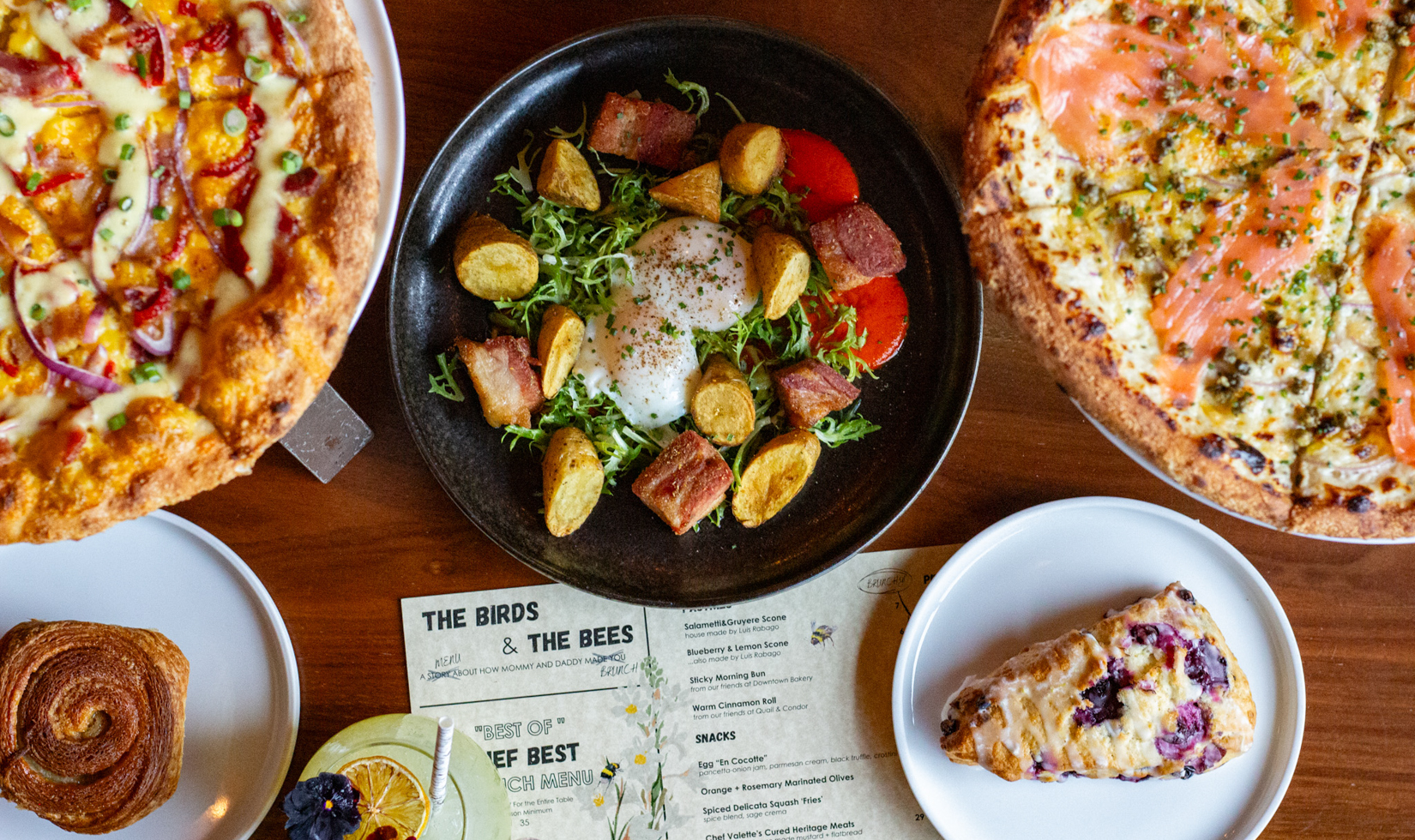 overhead photo of breakfast food including eggs and potatoes, breakfast pizzas and pastries