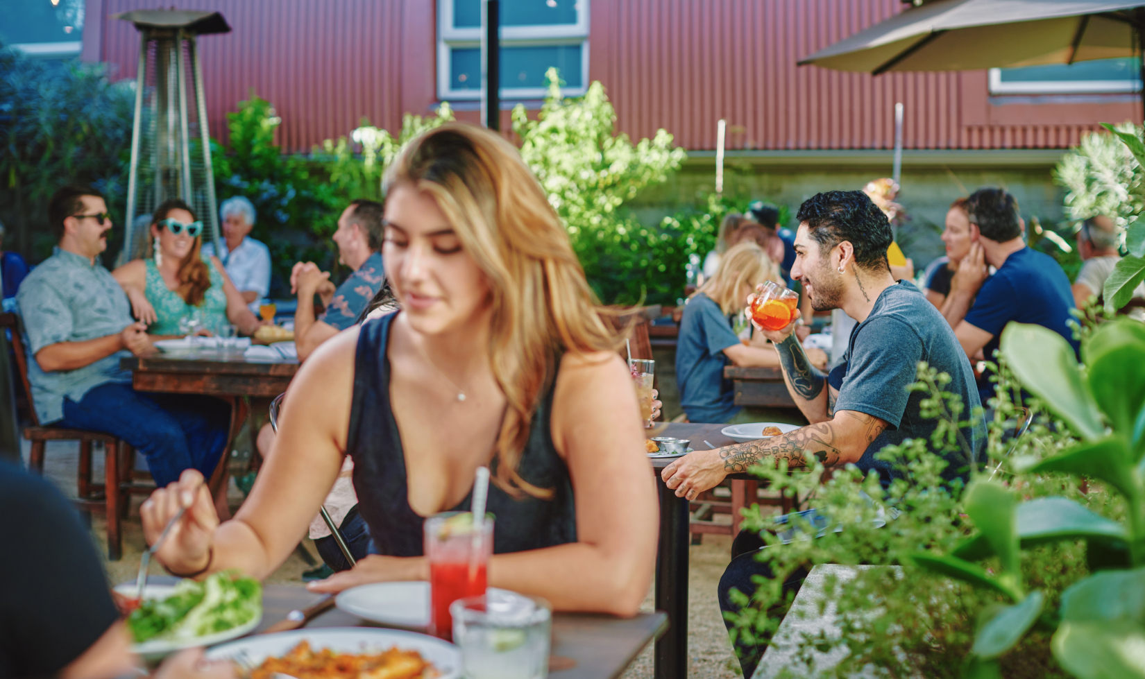restaurant garden with people eating and drinking at tables