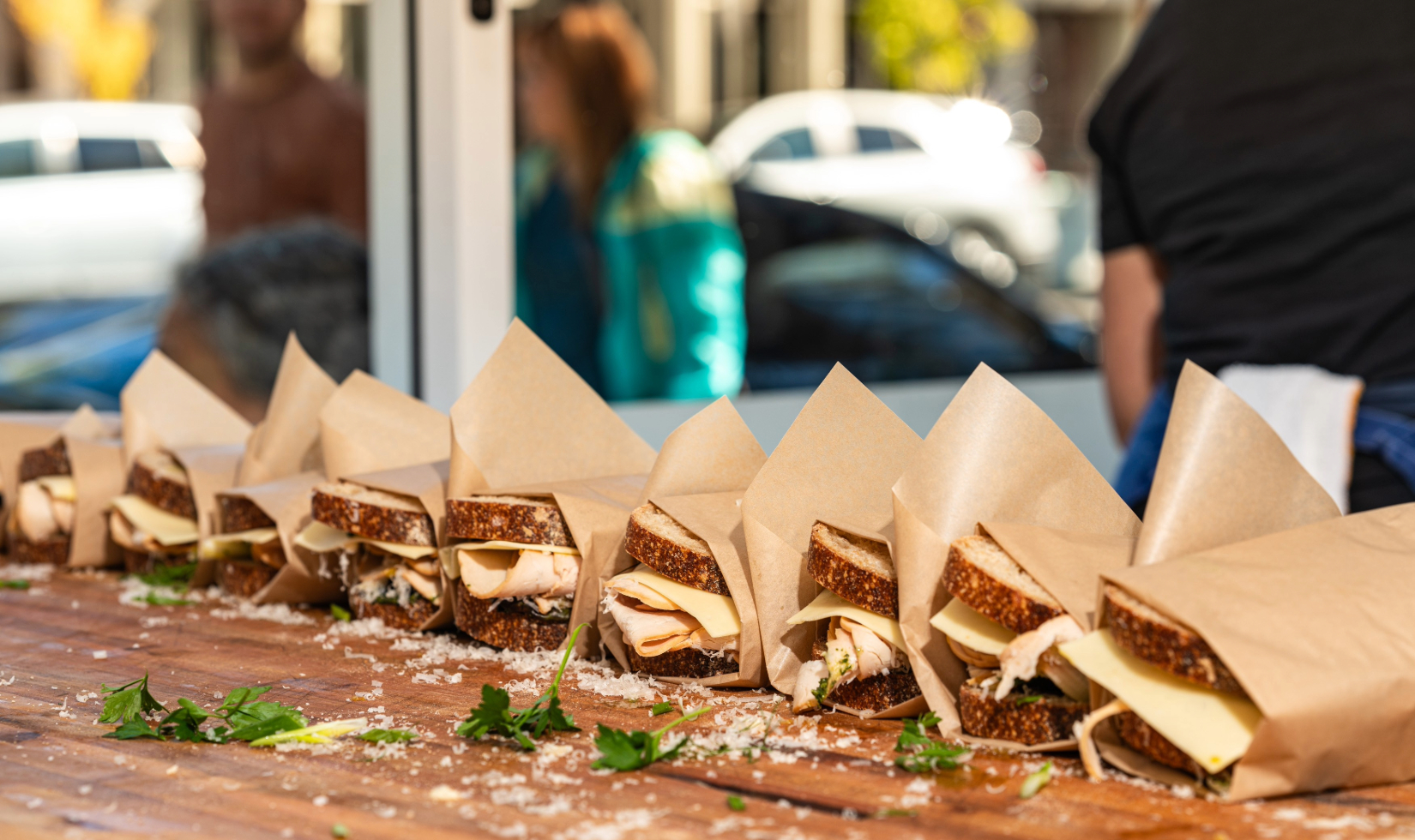 sandwiches in row on wooden counter