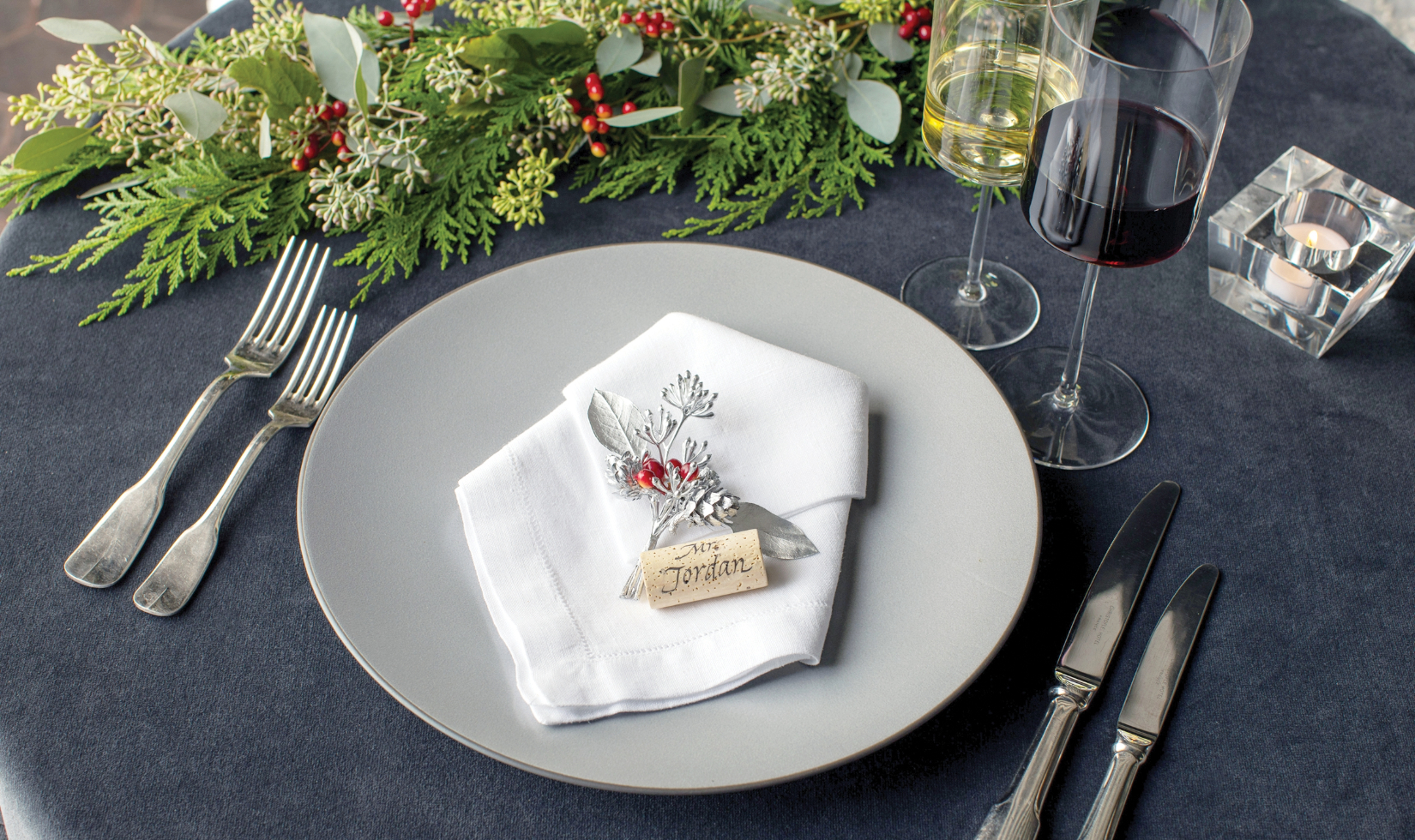 Table setting with mistletoe charm on plate with cork inscribed with "Mr Jordan". 