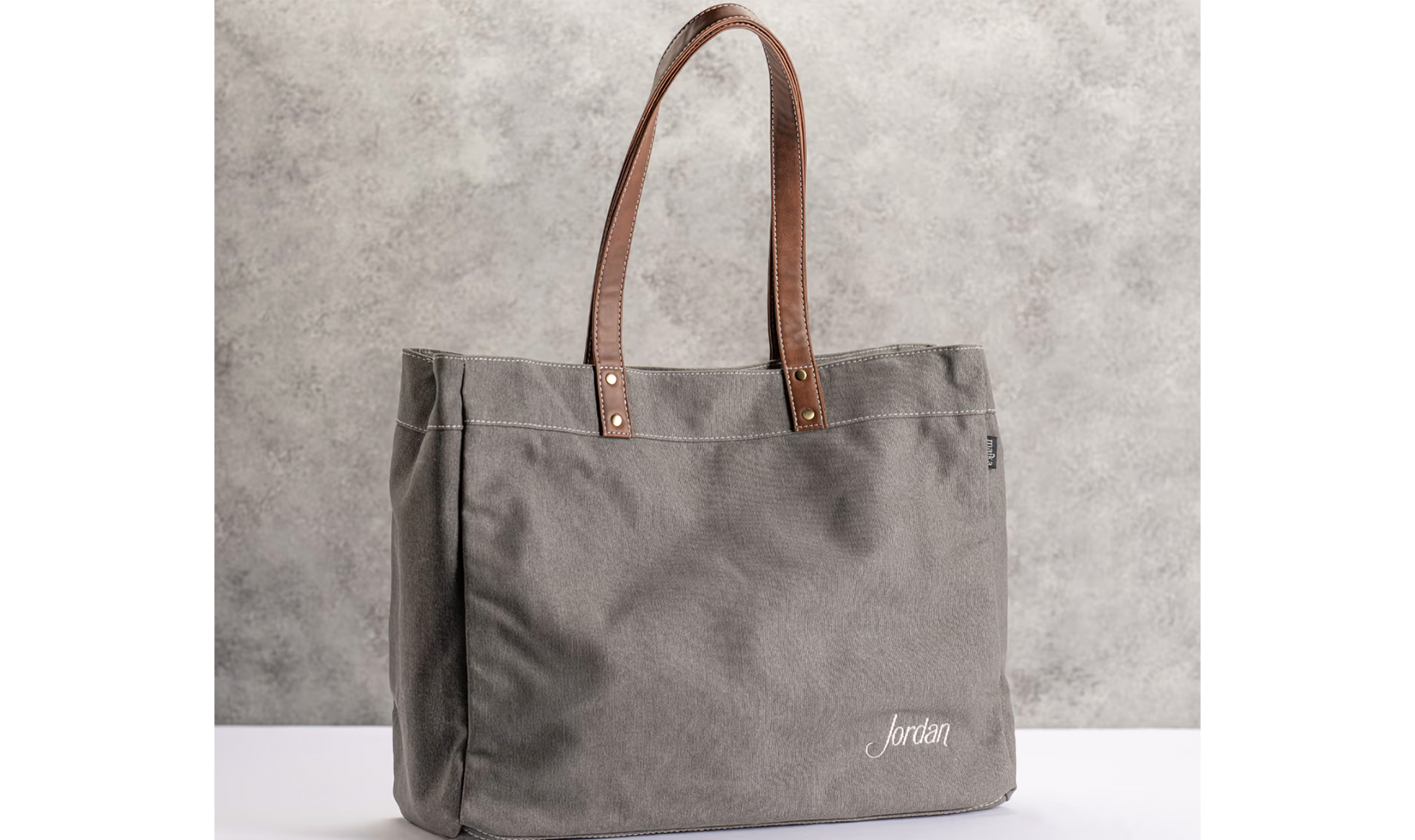 Gray tote bag with "Jordan" embroidery.