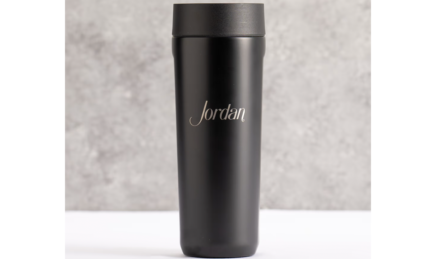 Black tumbler with "Jordan" engraving.