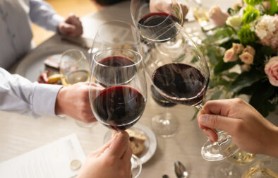cabernet glasses toasting around a formal dinner table