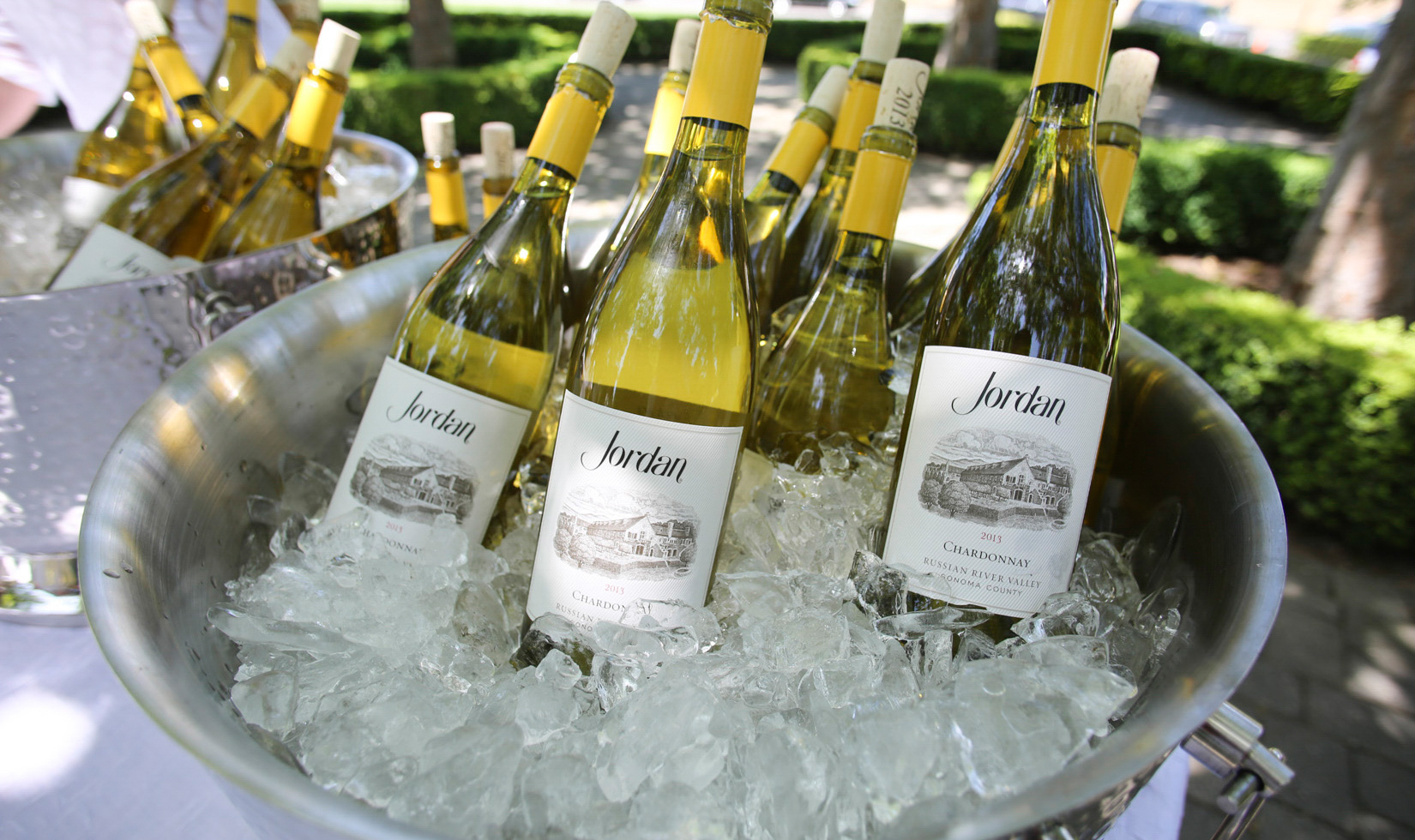 bottles of chardonnay in multiple wine buckets
