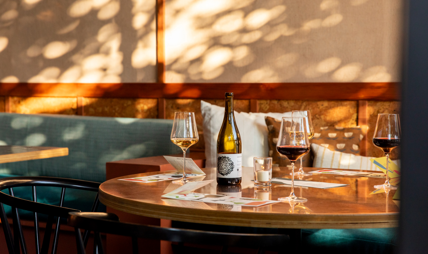 an open bottle of wine with wine glasses on the table at a wine tasting lounge